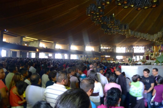 There are the tens of thousand packed into the new Church taking part in the service.